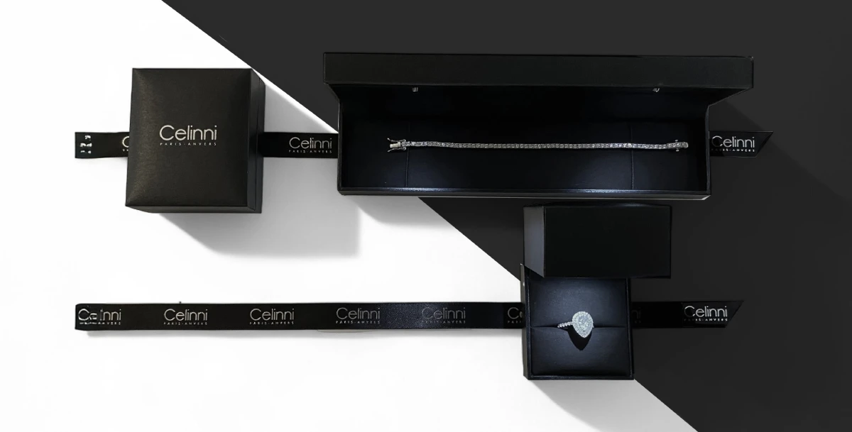 Boîtes de bijoux Celinni, avec un bracelet et une bague sertie de diamants exposés dans un design élégant noir et blanc.