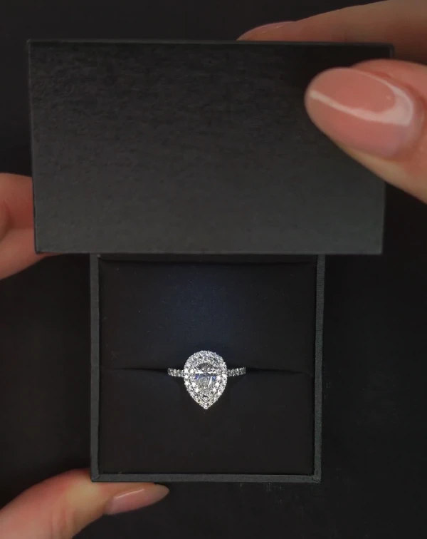 Bague en diamant en forme de poire dans un écrin noir élégant