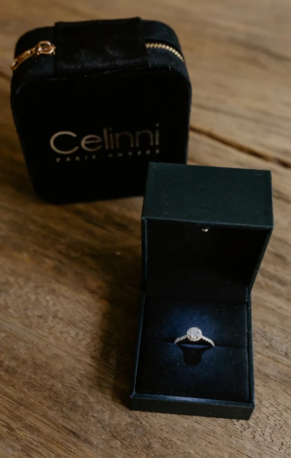 Diamond ring in its elegant black box. Diamond ring elegantly presented in a luxurious black box, placed on a natural wood surface.