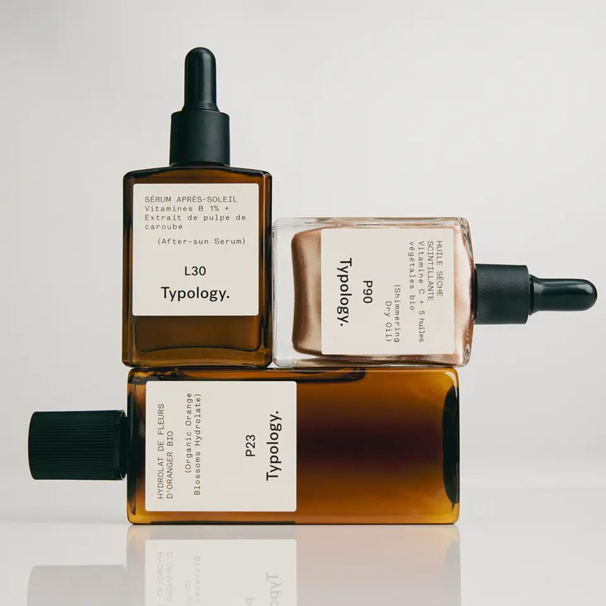 Trio de soins Typology comprenant un hydrolat bio, un sérum après-soleil vitamines B et une huile sèche scintillante pour hydrater et réparer la peau après l'exposition au soleil